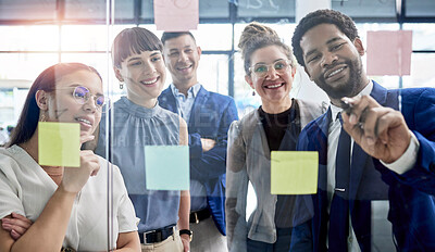 Buy stock photo Business people, writing and meeting in schedule planning for brainstorming, teamwork or tasks on glass board at office. Happy group of employees in sticky note project plan for strategy at workplace