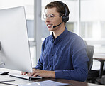 Man, call center and typing on computer, smile in office and working on customer service in workplace. Telemarketing, desktop and happiness of person, male sales agent or consultant consulting online