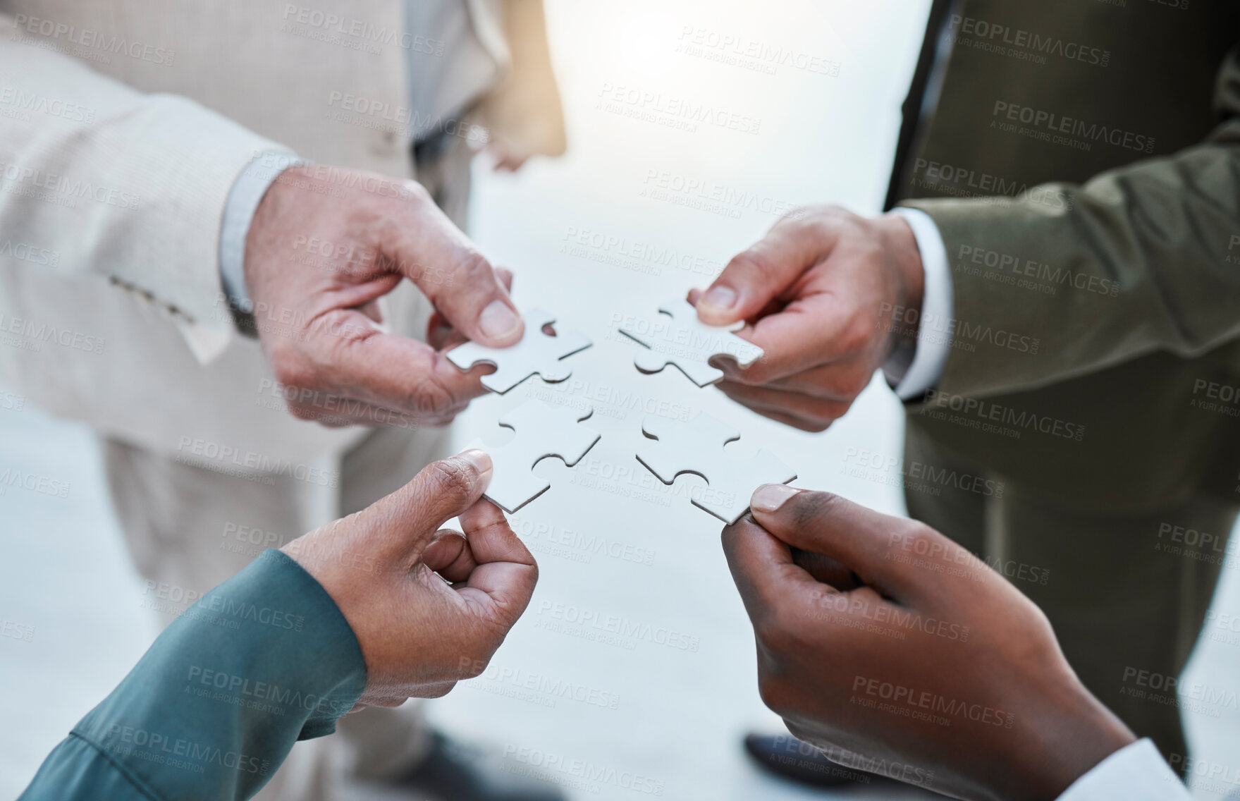 Buy stock photo Hands, puzzle or collaboration with a business team closeup in an office for planning from above. Teamwork, strategy and jigsaw pieces with a group of employee people or colleagues working in synergy