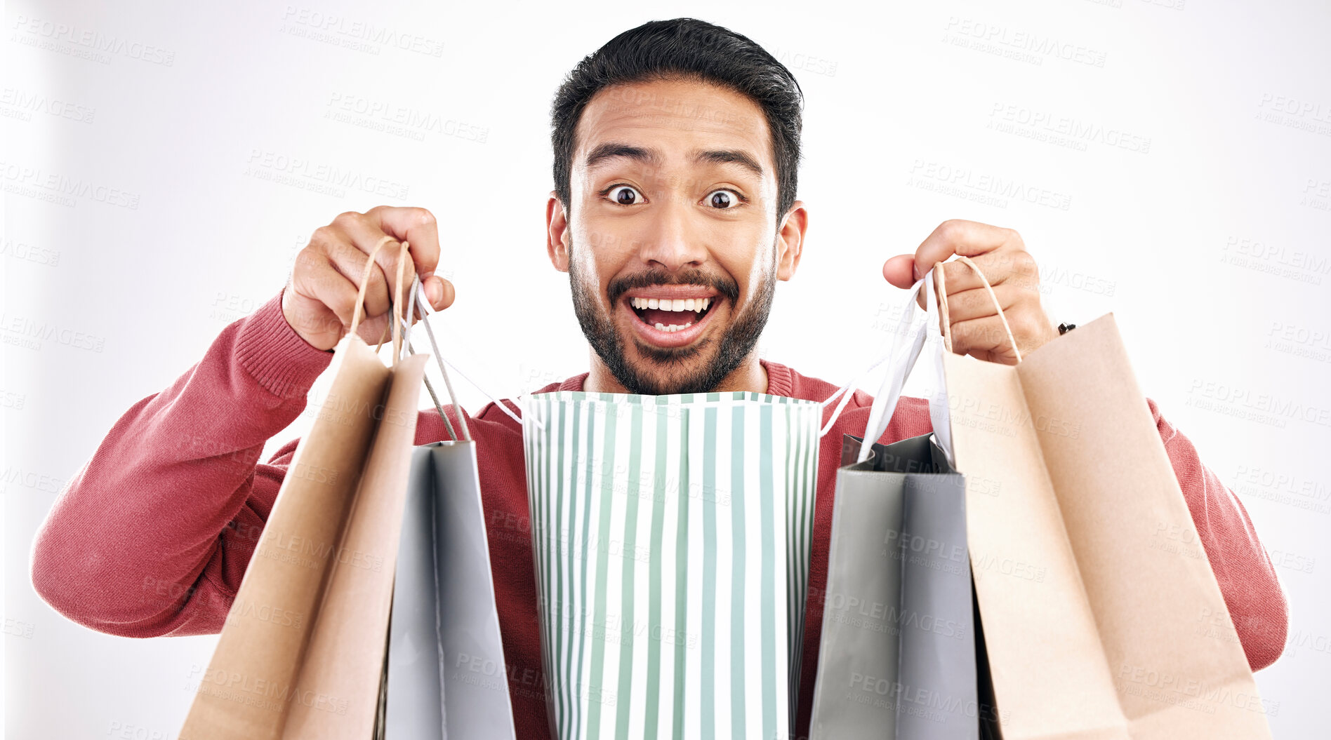 Buy stock photo Wow, sale and portrait of man with shopping bag in studio, excited for discount or purchase on white background. Deal, face and indian guy with product from shop, mall or market while posing isolated