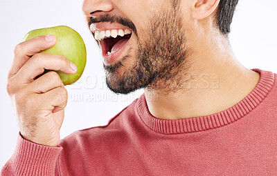 Buy stock photo Hand, apple and man in studio for diet, nutrition and weight loss with healthy breakfast on white background. Fruit, snack and male nutritionist eating organic, clean and fiber detox routine isolated