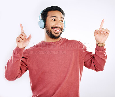 Buy stock photo Headphones, smile and male dancing in a studio to music, playlist or album for entertainment. Happiness, dance and Indian man model moving to the radio or streaming a song by a white background.