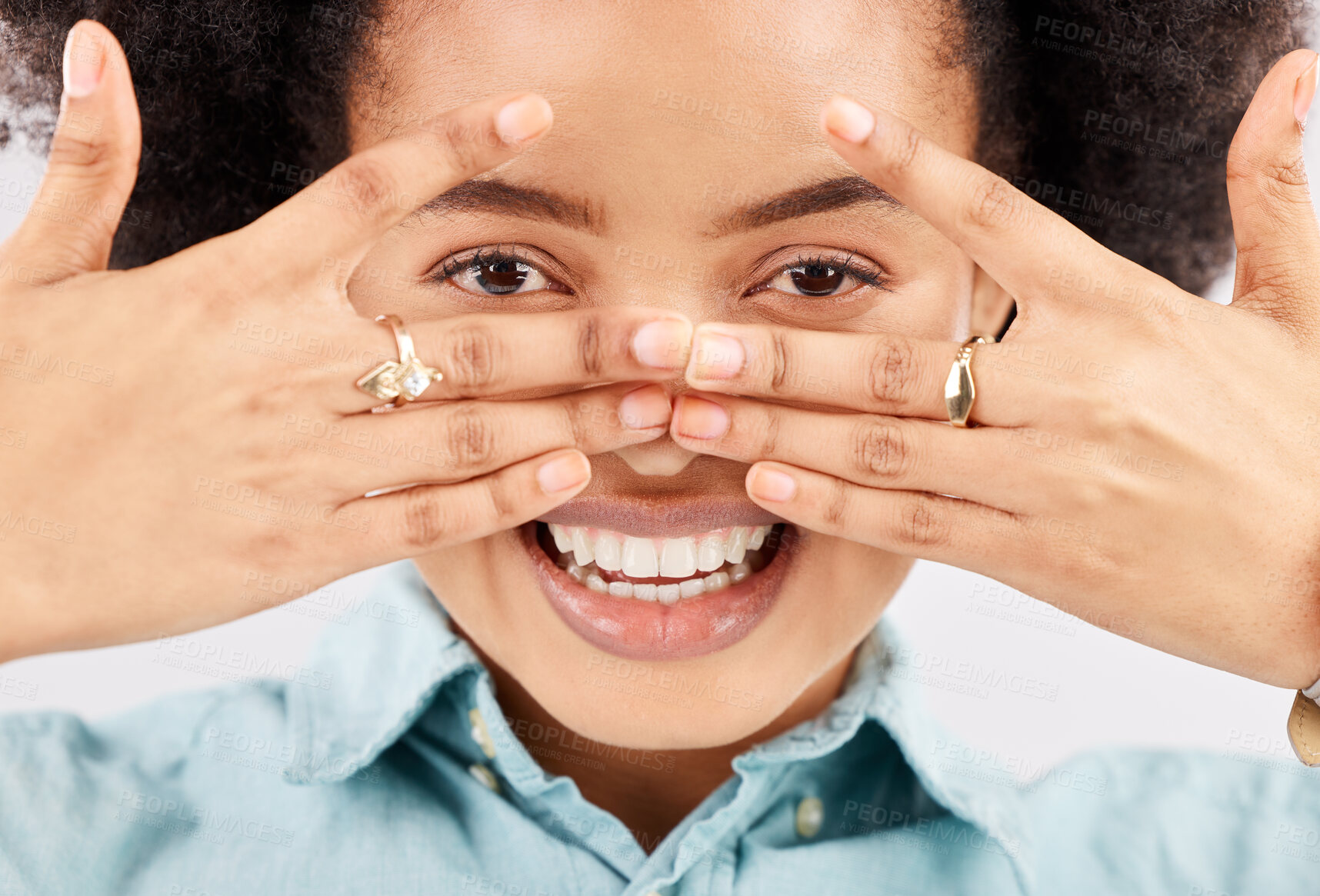 Buy stock photo Portrait, eyes and hands with a woman in studio, feeling playful or joking for comedy and humor. Face, smile and hand gesture with a funny young female looking happy with a positive attitude