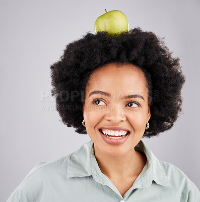 Buy stock photo Thinking, apple on head and black woman with smile, health and nutrition against a grey studio background. African American female, fruit and happy lady with happiness, diet and wellness with ideas