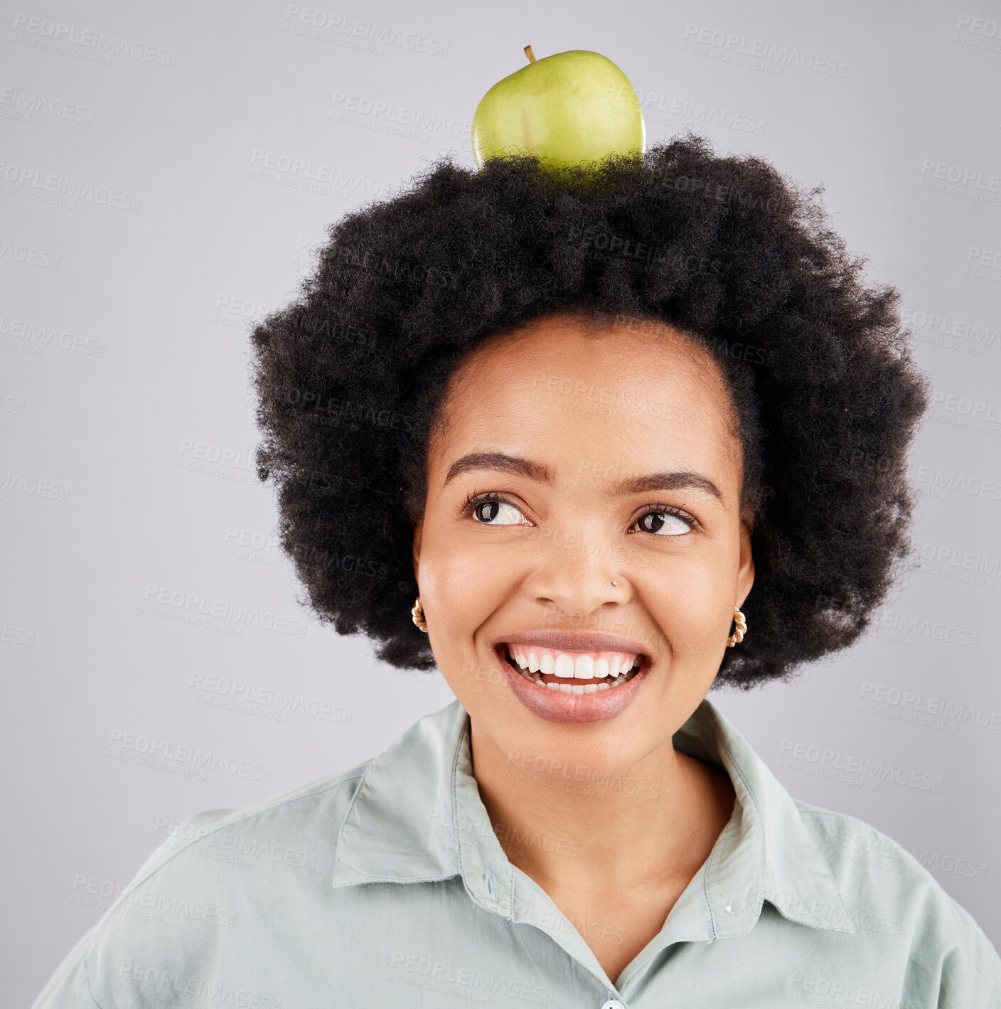 Buy stock photo Thinking, apple on head and black woman with smile, health and nutrition against a grey studio background. African American female, fruit and happy lady with happiness, diet and wellness with ideas