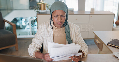 Buy stock photo Laptop, stress and documents with a business muslim woman reading information in her office. Tax, audit or bankruptcy with a young employee looking frustrated at paper during a financial crisis