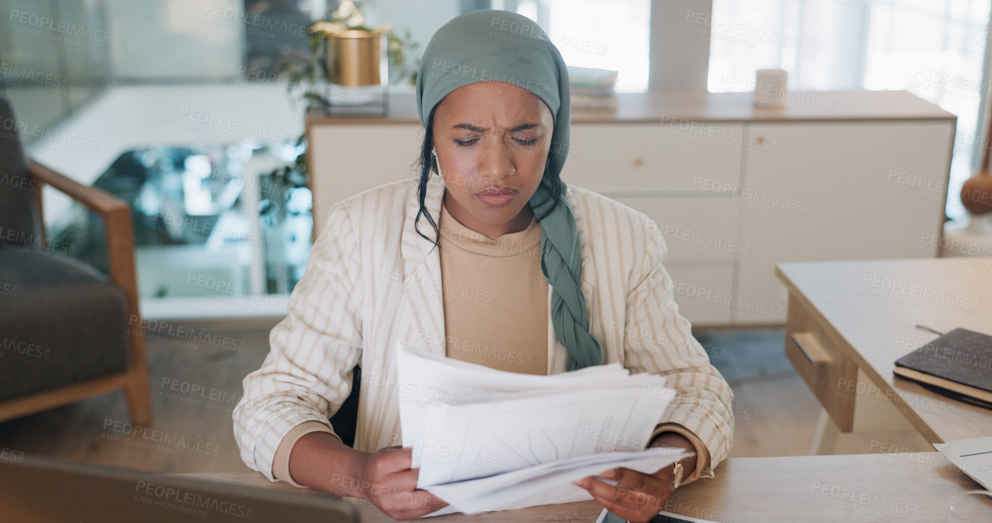 Buy stock photo Laptop, stress and documents with a business muslim woman reading information in her office. Tax, audit or bankruptcy with a young employee looking frustrated at paper during a financial crisis