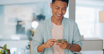 Cellphone, networking and Asian man on social media in the office typing on a lunch break. Technology, happy and male employee with a smile browsing internet or mobile app with cellphone in workplace