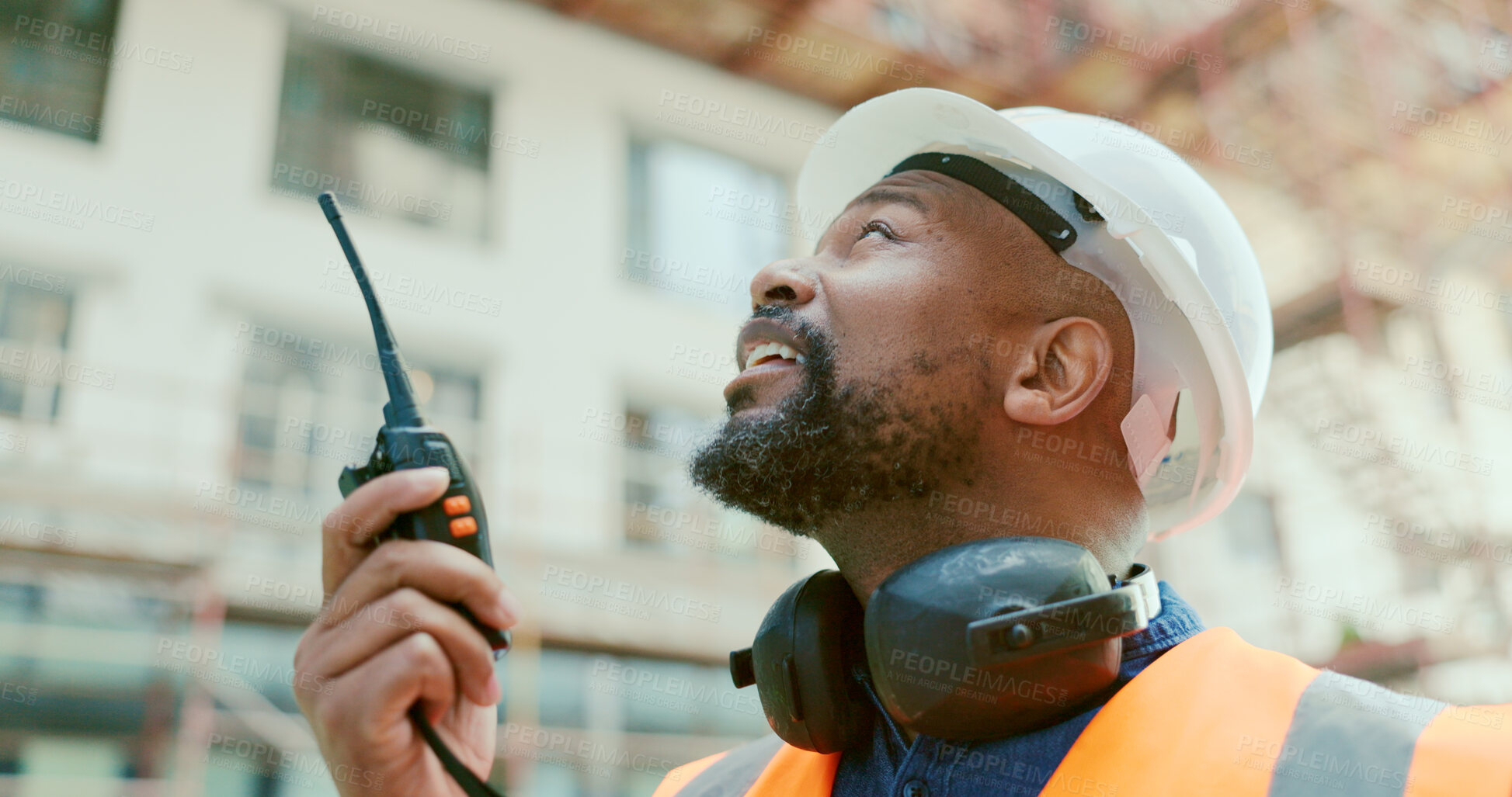 Buy stock photo Building, radio and a black man construction worker on a site for project management or development. Communication, safety and an engineer talking on a walkie talkie for industrial architecture