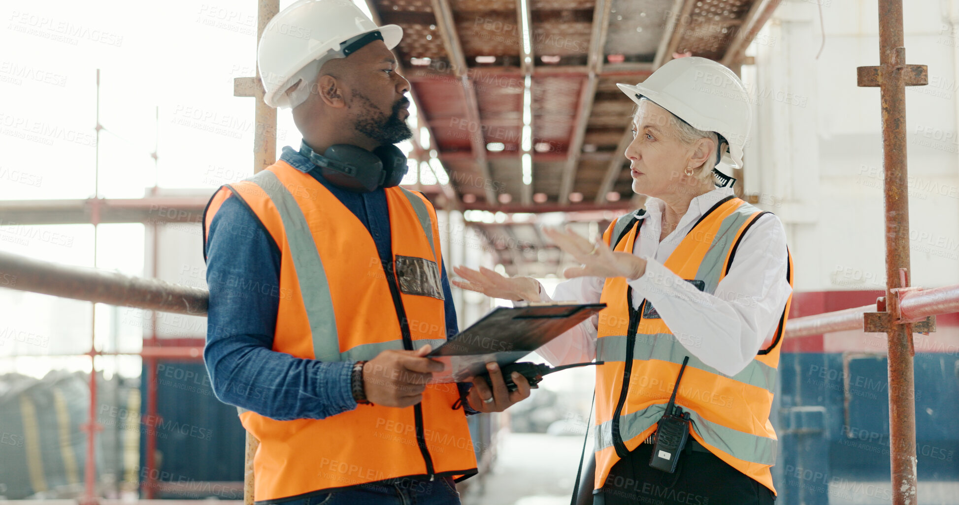 Buy stock photo Construction, inspection and man with checklist talking to woman in engineering on site with scaffolding and building renovation. Contractor, survey and list of industrial maintenance safety rules