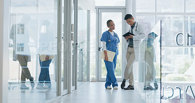 Buy stock photo Doctors, partnership and hospital with tablet, talk and ideas in meeting, discussion or strategy with planning. Medical staff, team and analysis for wellness, consulting or feedback in clinic hallway