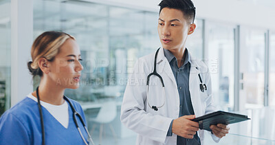 Buy stock photo Tablet, consulting and teamwork with doctors in hospital for results, digital chart and medicine. Healthcare, medical and research with people walking in clinic for surgery, wellness and feedback