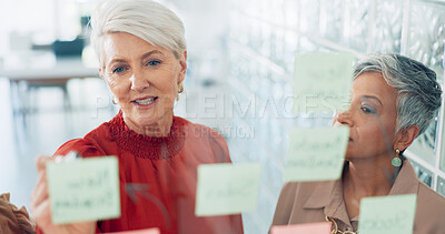 Buy stock photo Business people, writing and teamwork in schedule planning, brainstorming or tasks on glass board at office. Women in team project plan or agenda for corporate, solution strategy or idea at workplace