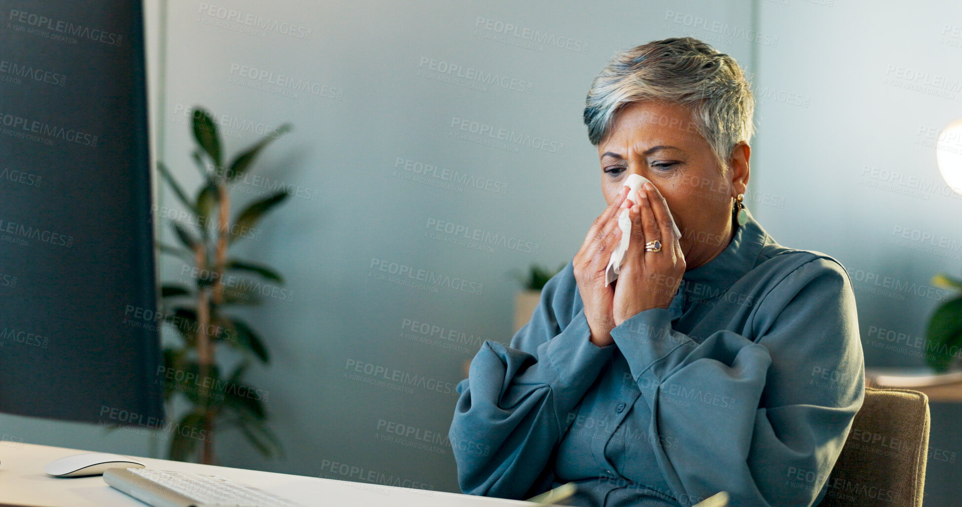 Buy stock photo Sick business woman blowing nose at desk for allergies, virus and working late on computer in office. Mature worker, sneeze and infection of influenza, bacteria or health risk, sinusitis and hayfever