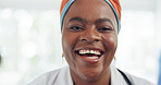 Happy, smile and face of a doctor in the hospital lobby after healthcare or medic consultation. Happiness, excited and portrait of black woman medical nurse standing in the hallway of medicare clinic