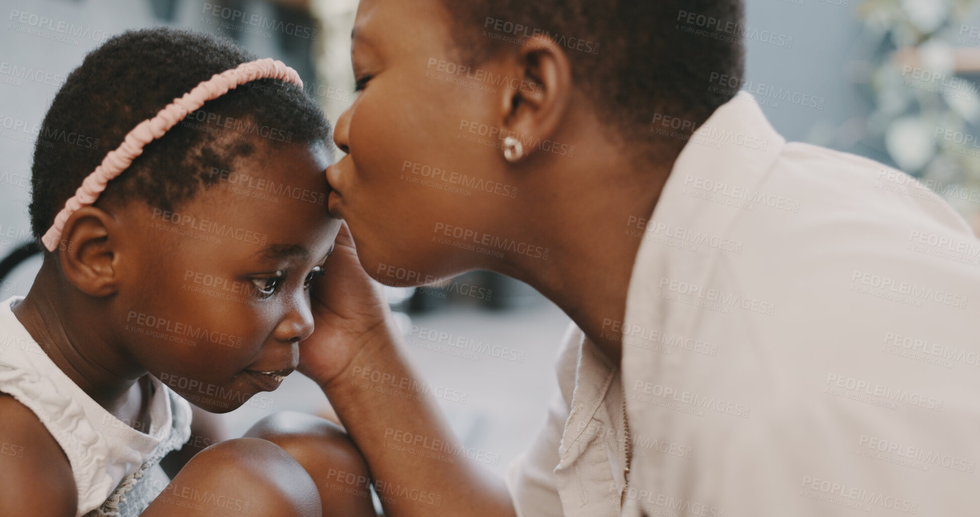 Buy stock photo Mother, girl and kiss on forehead for love, support and care or comfort in home kitchen with connection. Black woman, child and bonding at family house for quality time, development and growth