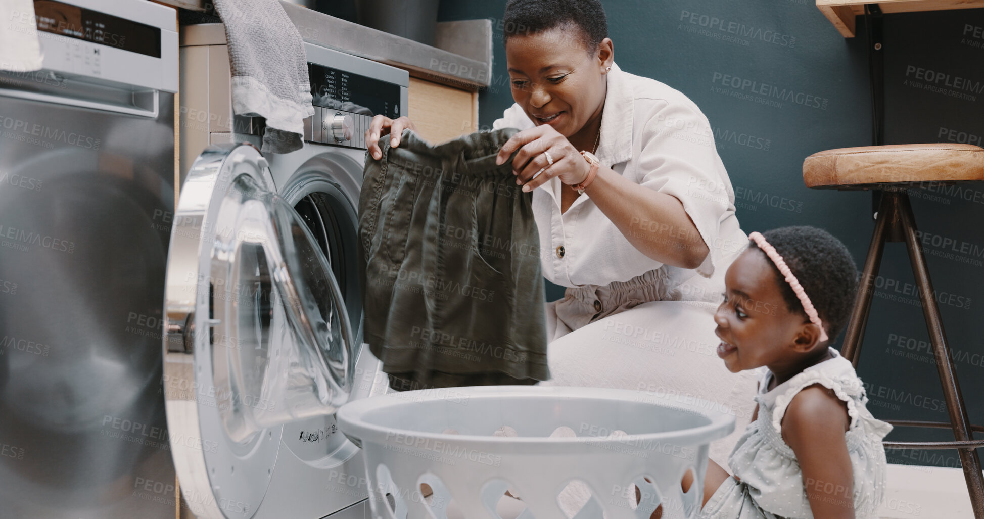 Buy stock photo Laundry, washing machine and a black woman teaching her daughter about hygiene or chores in the home. Family, cleaning and housework with a young girl learning about housekeeping from her mother