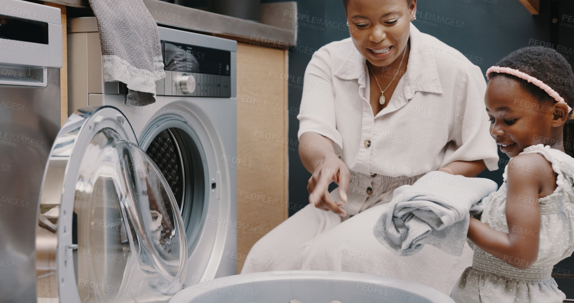 Buy stock photo Laundry, washing machine and a mother teaching her daughter about hygiene or chores in the home. Family, cleaning and housework with a young black girl learning about housekeeping from her parent