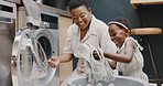 Laundry, mother and child helping with folding of clothes together in a house. Happy, excited and young girl giving help to her mom while cleaning clothing from a washing machine in their home