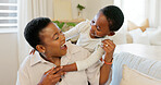 Love, mother and excited child hug playing together bonding in bedroom at house. Happy black woman and baby affection smile, trust and support care or enjoy spending quality time at family home