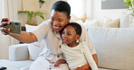 Smartphone, selfie and mother with child on living room sofa for social media post, parents blog update or family home celebration. Black family smile in cellphone portrait photography for online app