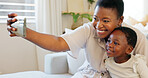 Smartphone, selfie and mother with child on living room sofa for social media post, parents blog update or family home celebration. Black family smile in cellphone portrait photography for online app