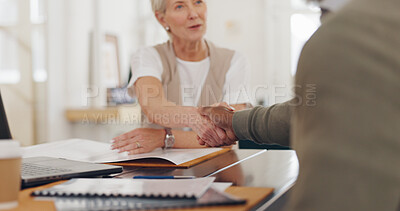 Elderly business people, handshake and b2b for partnership, trust or deal agreement at the office table. Senior woman and man shaking hands for business meeting, interview or welcome at the workplace