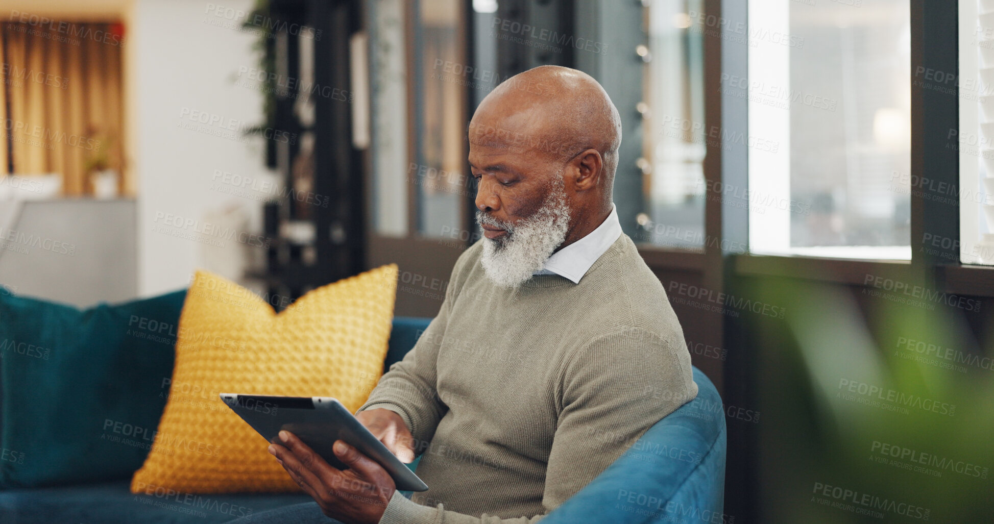 Buy stock photo Mature, man and tablet to read on sofa for work, online shopping or retirement at home. African, person and elderly with technology for social media, browsing or relaxing on holiday, vacation or trip