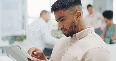 Buy stock photo Tablet, networking and businessman in the office reading an email on the internet for communication. Professional, digital technology and Indian male designer doing research on website in workplace.