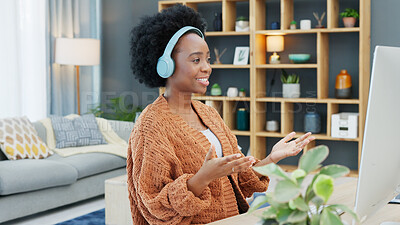 Call center agent talking and helping customers while wearing a headset and working on a desktop computer at home. Happy and cheerful black woman working in sales and networking with clients online