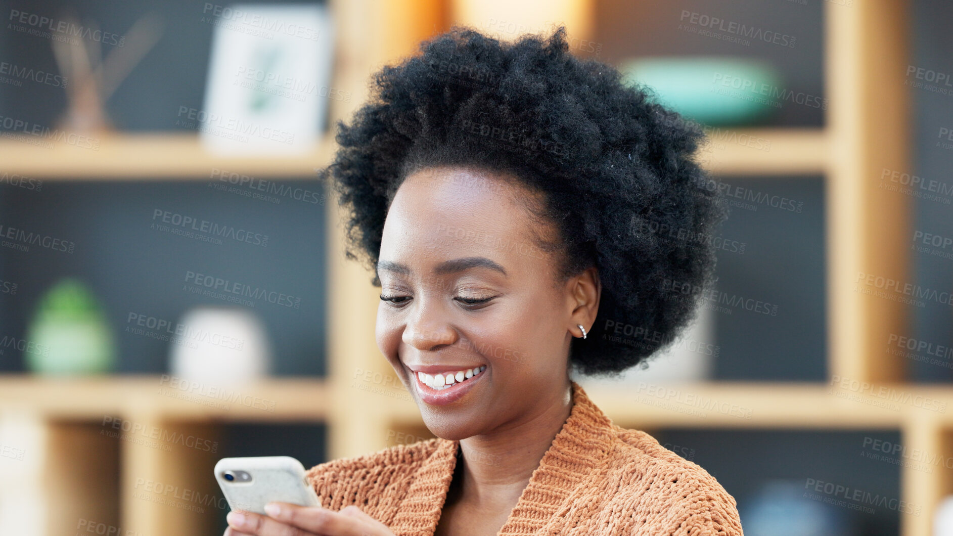 Buy stock photo Black woman, typing and smile for phone, chat and social media communication in Nigeria home or living room. Watching, video or reading funny internet meme or email on mobile app or search online