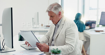 Business man, computer and documents while working in a office for data analysis while typing online doing research. Senior entrepreneur at his desk with a file for information on a finance report