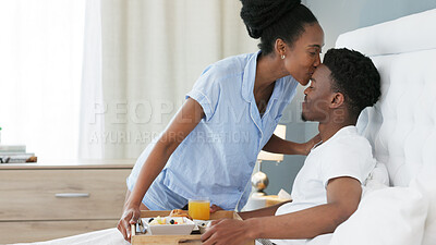 Black couple, love bond or breakfast in bed with kiss on forehead for happy, smile or trust in house, home or hotel. Woman serving health food or juice drink in celebration of birthday or anniversary
