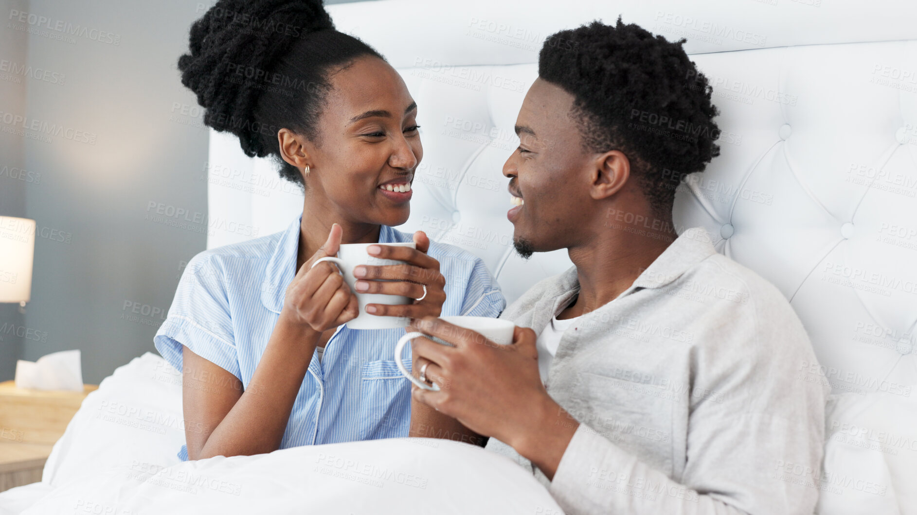 Buy stock photo Talking, coffee or happy black couple in bed together to relax on holiday vacation in home, house or hotel bedroom. Tea, morning or African people with love, care and speaking or communication