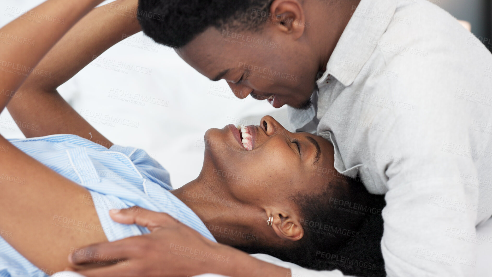 Buy stock photo Happy, black couple and romance in bedroom in the morning for love, relax and intimacy at house or home. Young, man and woman with smile and bonding together or wake up on a weekend with quality time