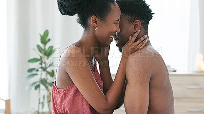 Black couple, laugh and sex intimacy kissing, bonding and enjoying foreplay in the bedroom at home. Happy African man and woman in sexual touch embracing relationship in love and happiness in bed