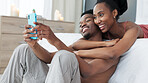 Portrait, phone and couple take a selfie in bedroom together and sharing it on social network app online in the morning. Social media, smile and black woman loves taking pictures with African partner