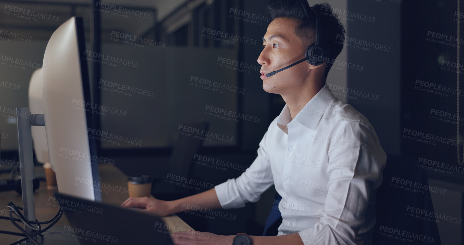 Buy stock photo Call center, contact and Asian man in dark office with support, computer and headset in communication. Telemarketing, customer service or overtime in crm, help desk consultant for night work online