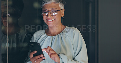 Smartphone, night and senior business woman on mobile app for global networking, funny meme or social media. Happy corporate worker using phone or cellphone in dark office for digital communication