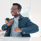 Dance, success and happy black man at work to celebrate a win ...