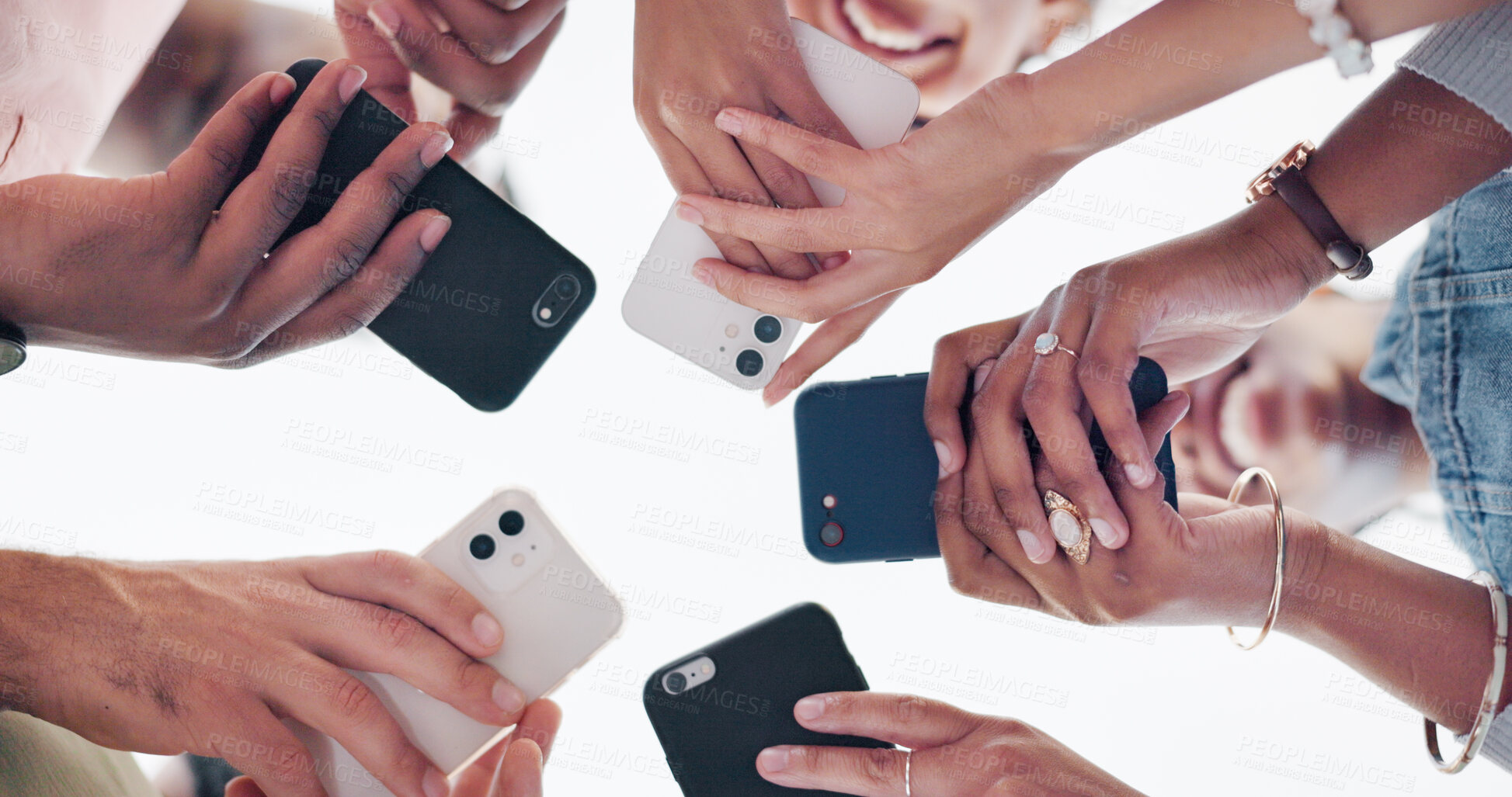 Buy stock photo Hands, phone and communication of group in a circle for networking online. Social media, mobile and connection of friends in low angle closeup on internet together, community gaming and typing on app