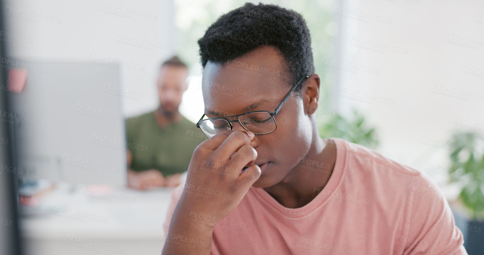 Buy stock photo Stress, headache and professional black man in the office doing research for creative startup company. Burnout, migraine and male designer working on a project with deadline in a modern workplace.