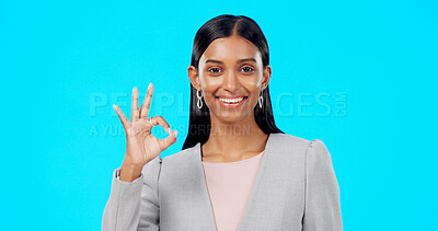 Buy stock photo Okay sign, business and portrait of Indian woman in studio for career, job and work opportunity. Professional, emoji and face of person on blue background with agreement, approval and yes gesture