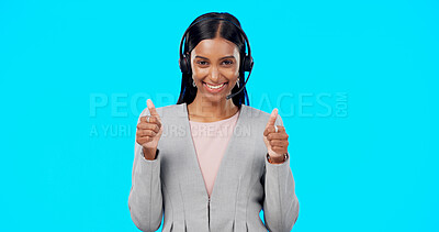 Call center, portrait or happy woman with thumbs up in studio for agreement on blue background. Smile, mockup space or Indian girl with like, success or yes hand sign at telecom crm customer services