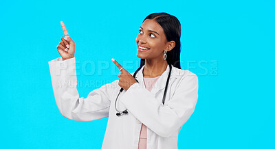 Buy stock photo Studio doctor, happiness and woman point at medical info, hospital direction or clinic service promotion, offer or notification. Medicine announcement, brand logo and pharmacist on blue background