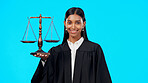 Portrait, balance scale or happy woman lawyer in studio for justice system, career services or marketing. Fair legal worker, mockup space or trusted Indian girl attorney with smile on blue background