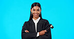 Lawyer, face and happy woman with gavel in studio, blue background and color backdrop. Portrait, female judge and legal attorney with arms crossed, smile and confidence for justice of constitution