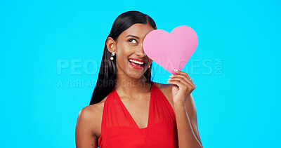 Thinking, happy or woman with heart paper sign for Valentines Day, studio care and emoji love icon, symbol or poster. Portrait, female beauty or person contemplating secret admirer on blue background