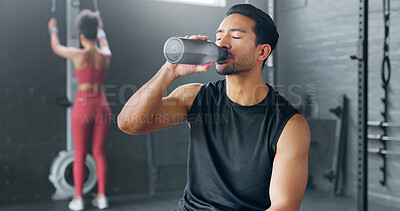 Buy stock photo Asian man, fitness and drinking water on break at gym after workout, training or indoor exercise. Active or sporty male person with mineral drink in rest for diet, natural nutrition or sustainability