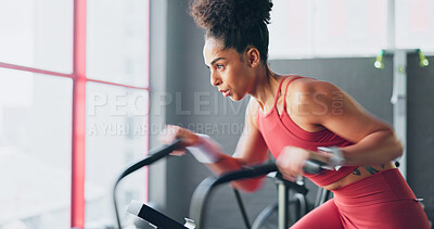 Exercise bike, cardio and girl cycling for sports fitness, athlete marathon training or high energy body workout. Gym performance motivation, wellness mindset and black woman riding bicycle machine